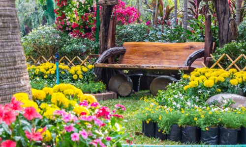 Wooden Bench In A Garden With Flowers